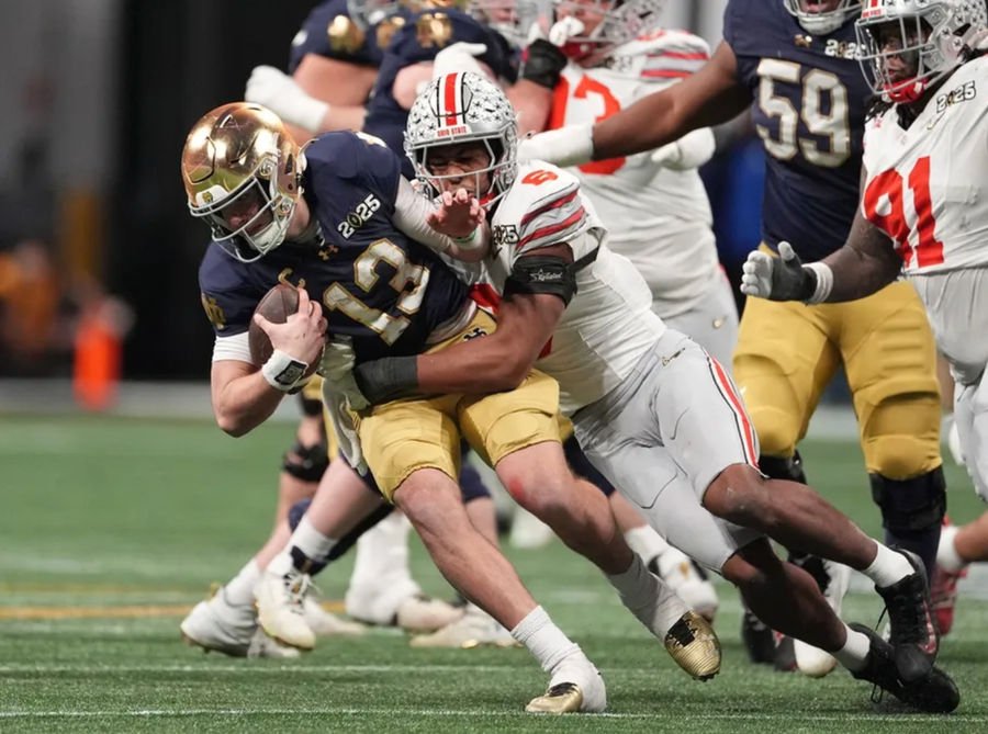 Jan 20, 2025; Atlanta, GA, USA; Notre Dame Fighting Irish quarterback Riley Leonard (13) is tackled by Ohio State Buckeyes safety Sonny Styles (6) in the second half in the CFP National Championship college football game at Mercedes-Benz Stadium. Mandatory Credit: Dale Zanine-Imagn Images